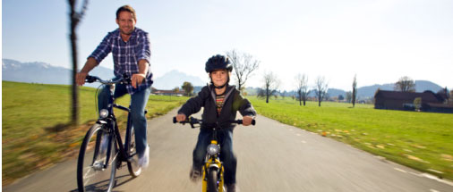 kid and father riding bicycle